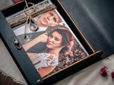 Black wooden photo box with personalized engraving on the lid for wedding photo presentation